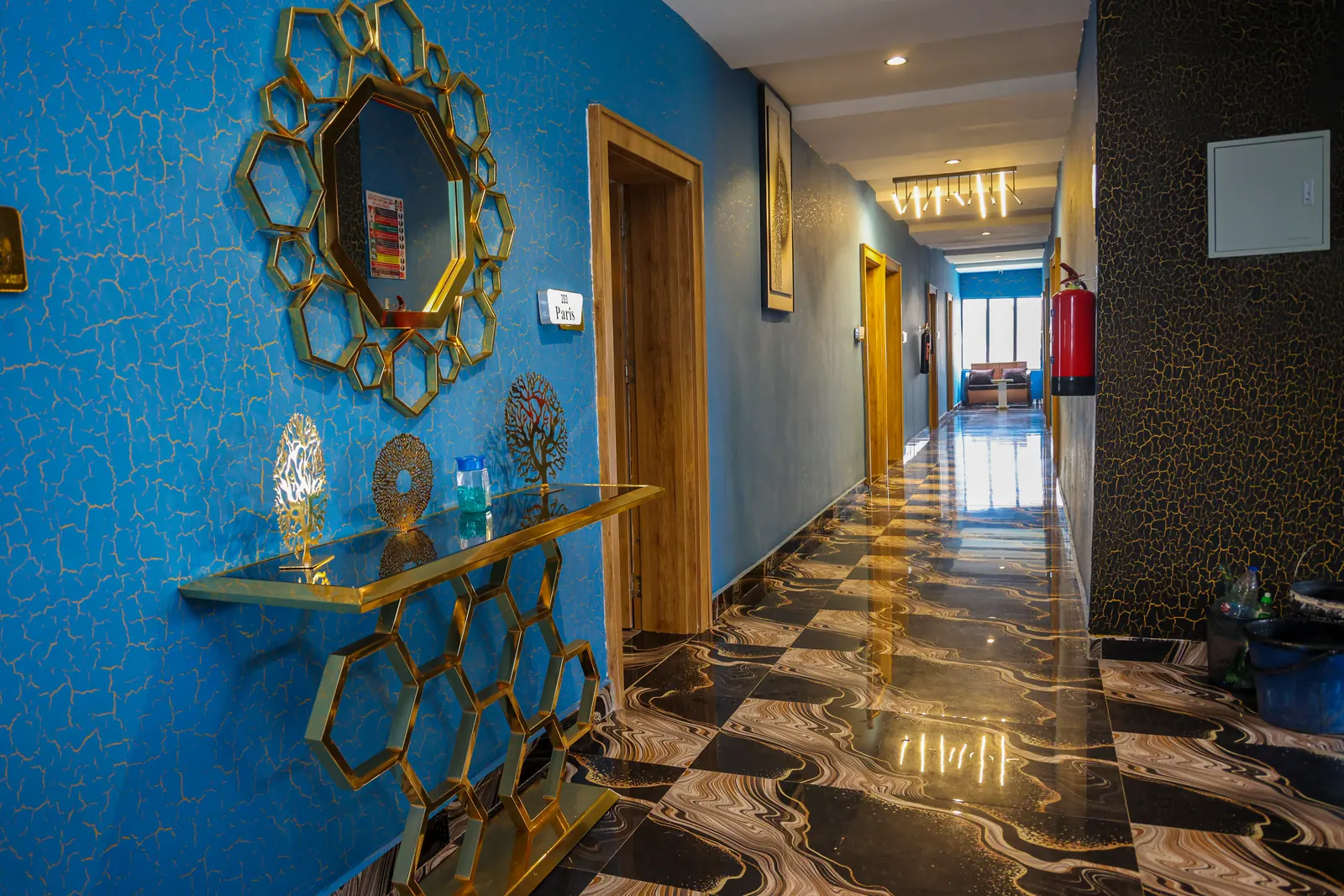 A guest-floor corridor, blue walls and patterned marble