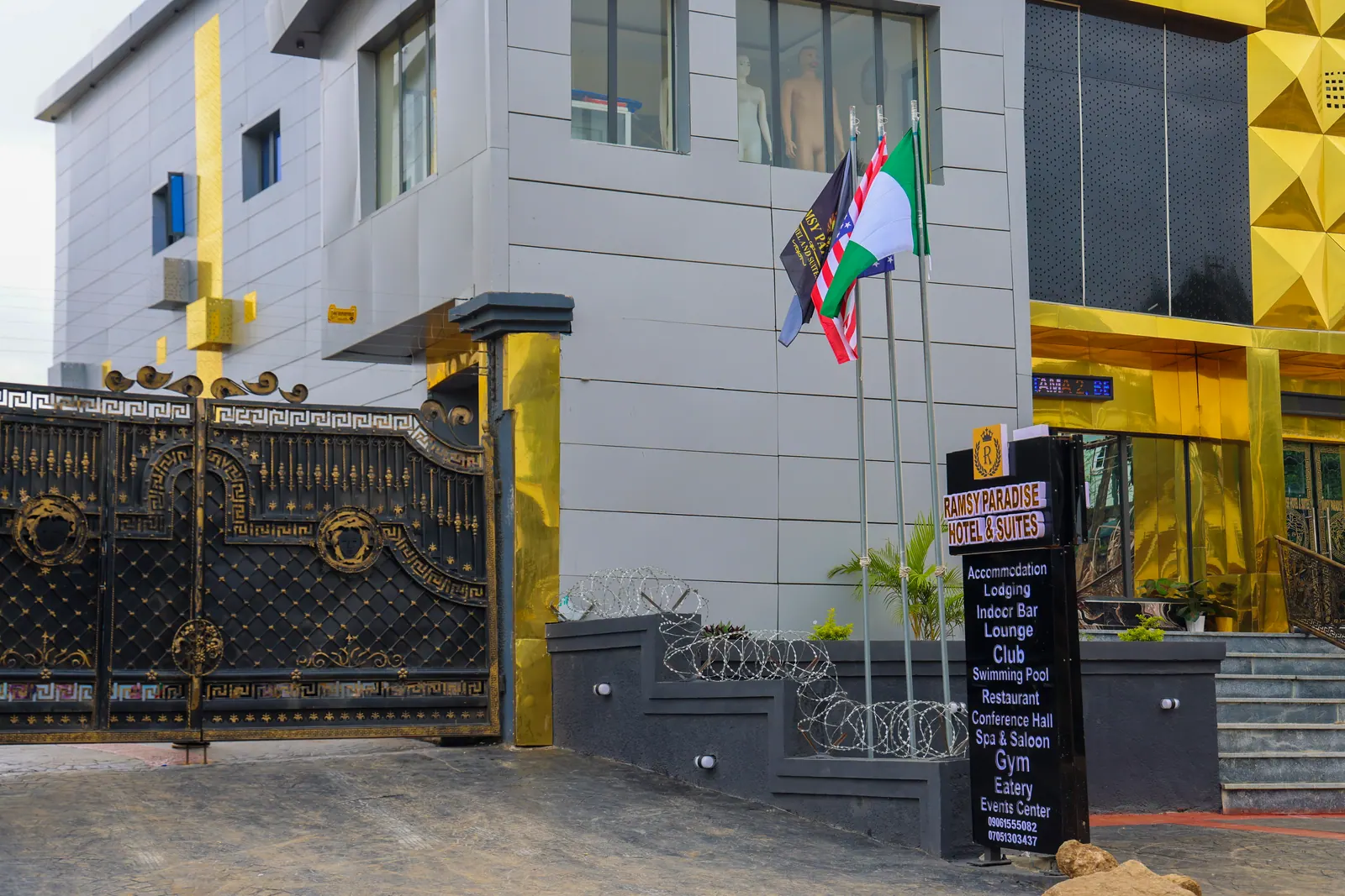 The entrance steps and signboard, with flags flying