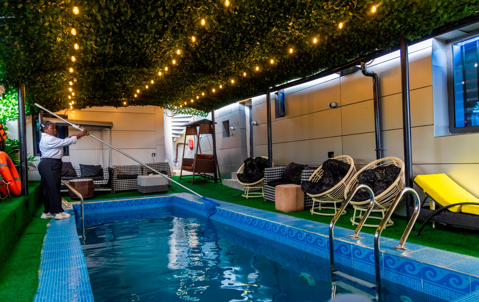 The outdoor swimming pool under festoon lights