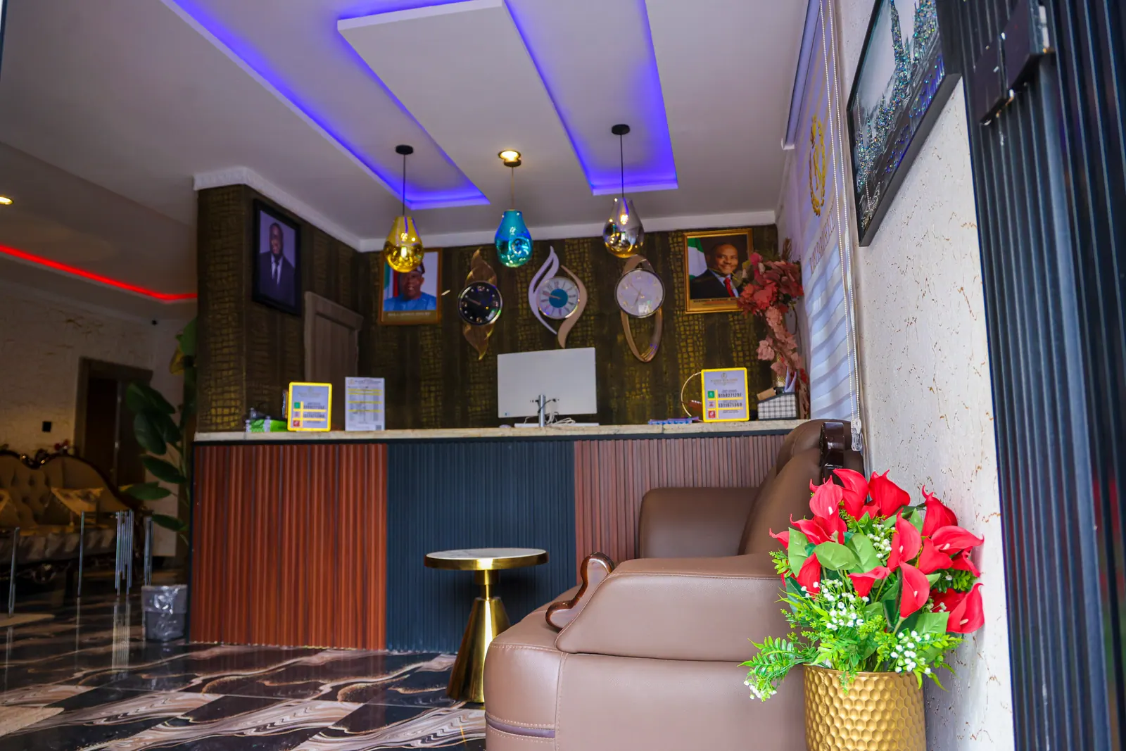 The reception desk, lit in blue and gold