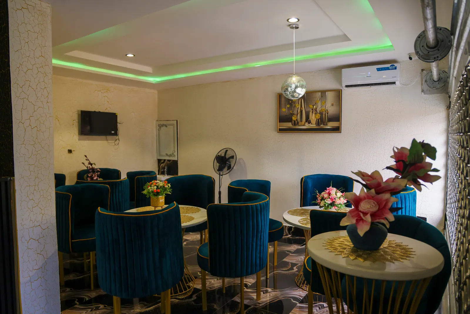 Restaurant tables with teal velvet chairs